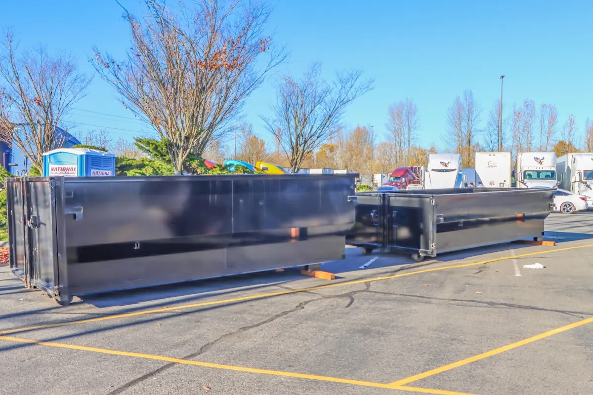 Professional dumpster rental service with roll-off container on residential driveway in Franklin